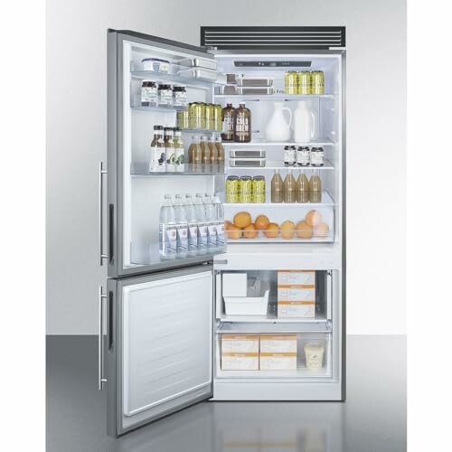 Open refrigerator filled with beverages, fruit, and groceries