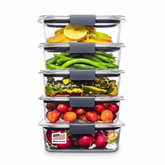 Stacked transparent food containers with fruits and vegetables.